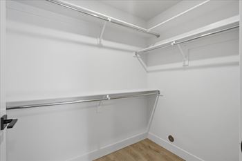 Large empty closet with wooden shelves2